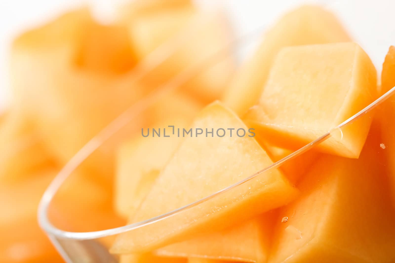 cantaloupe cut and in parfait glass light background