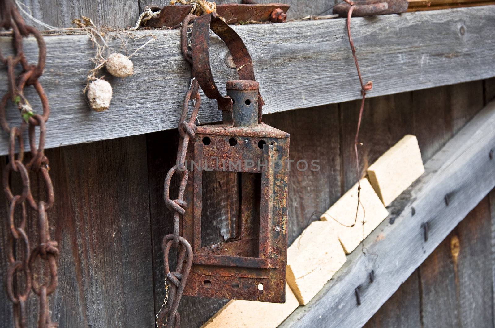 Rusty lamp on the old fence. Rural life close up.