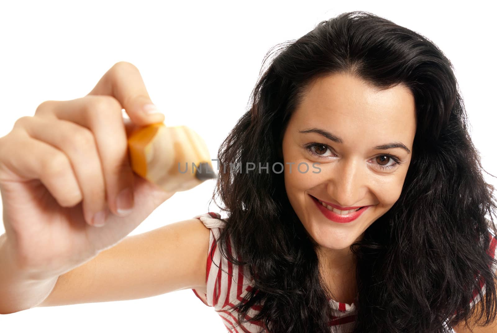 Young woman with big pencil drawing to camera isolated on white background by dgmata