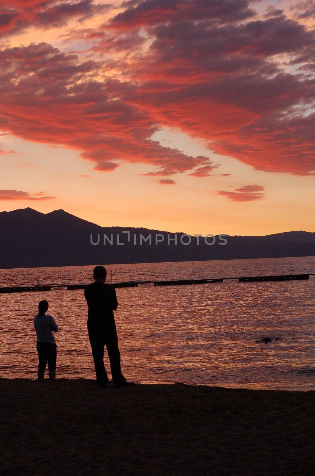 A couple watching cloud patterns at sunset