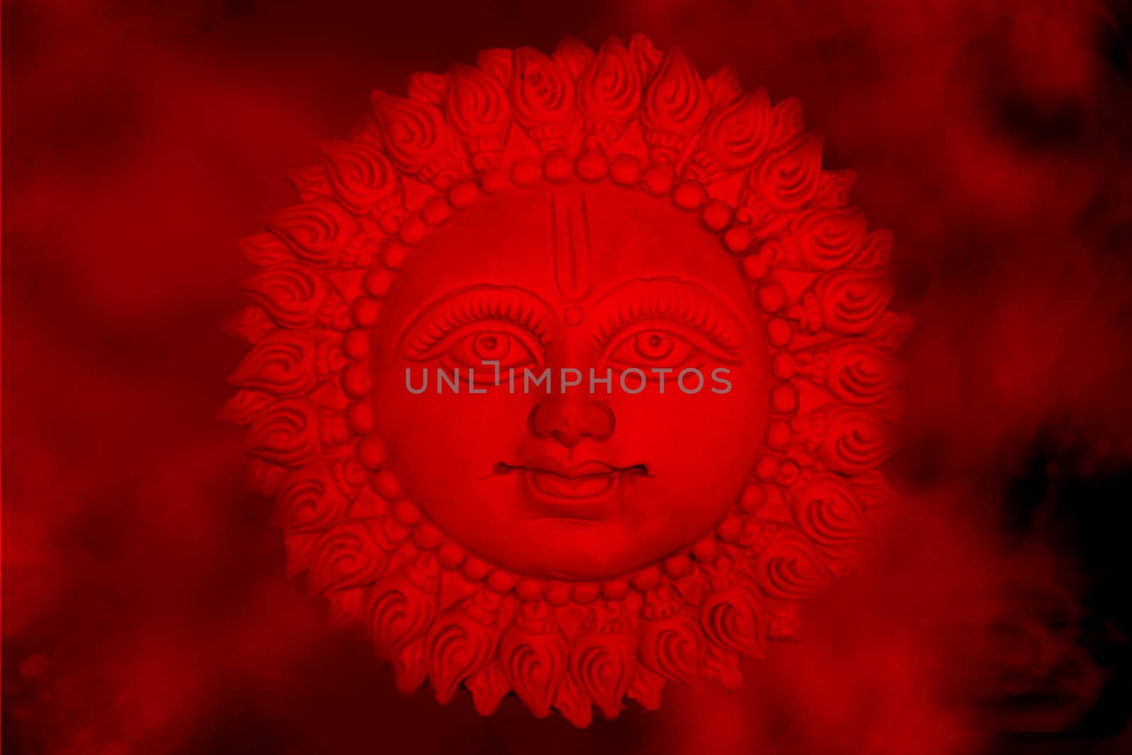 An abstract background of the Sun God according to Hinduism, in hot red clouds.