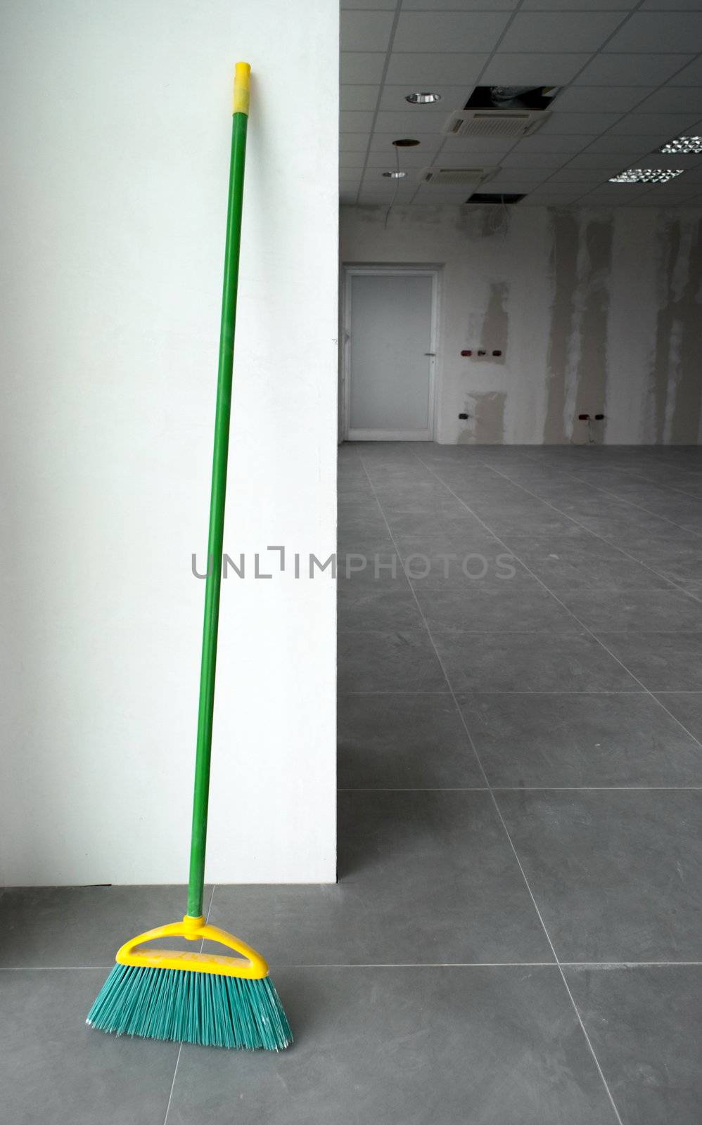 Broom in a cleaned constructed empty office