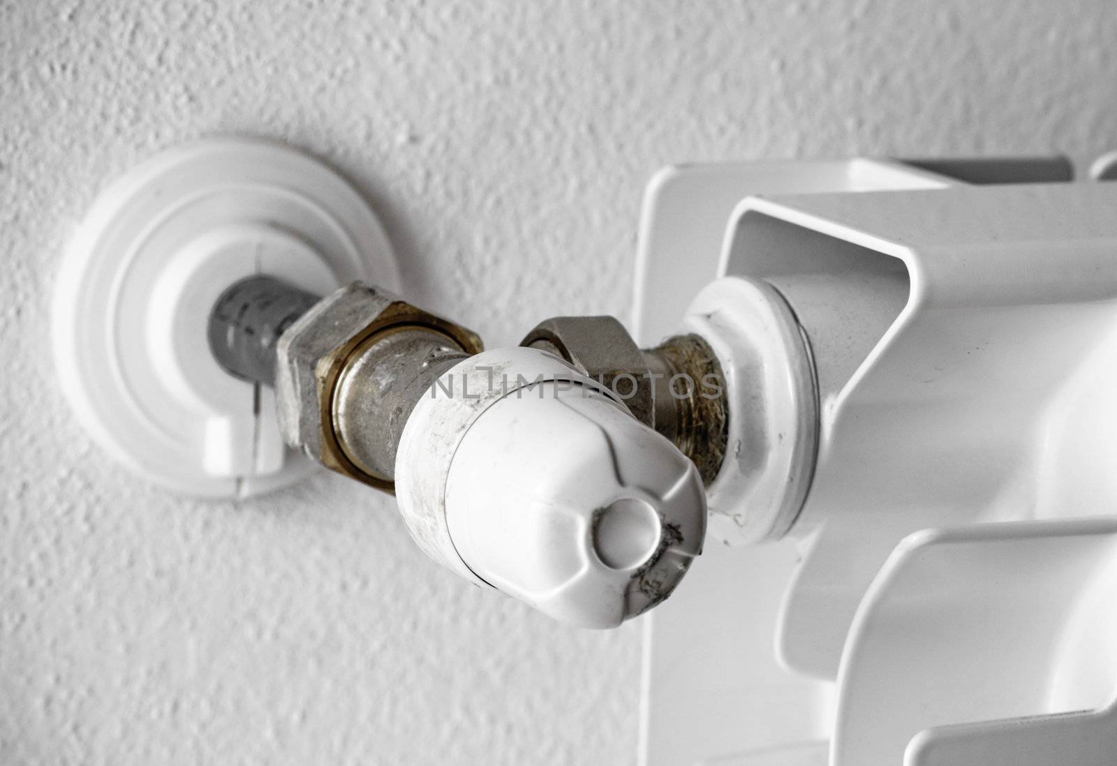 white radiator regulator on a white wall