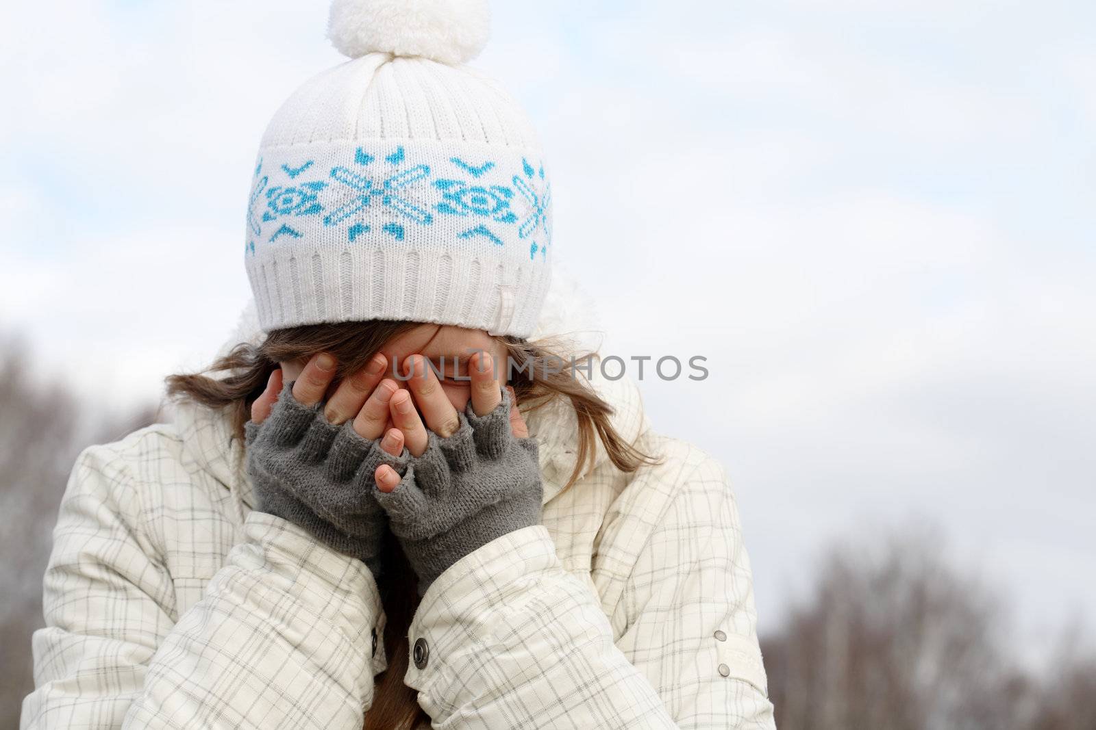 Nice young girl hide face behind her fingers
