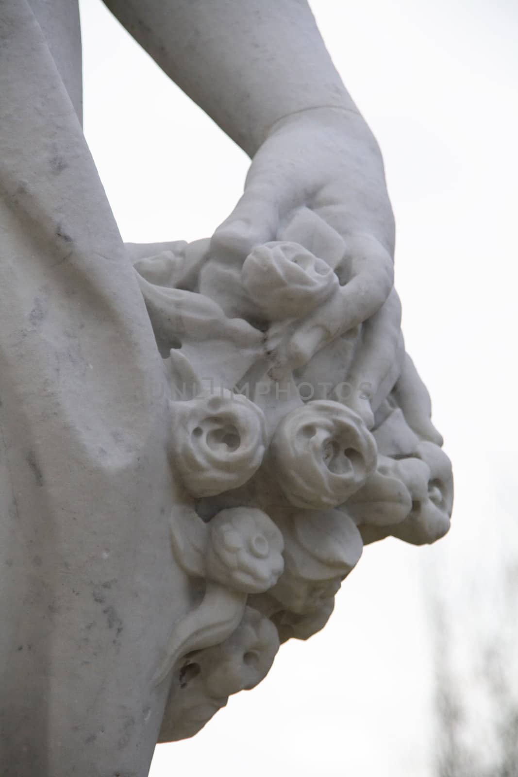 Part of an antique statue holding roses