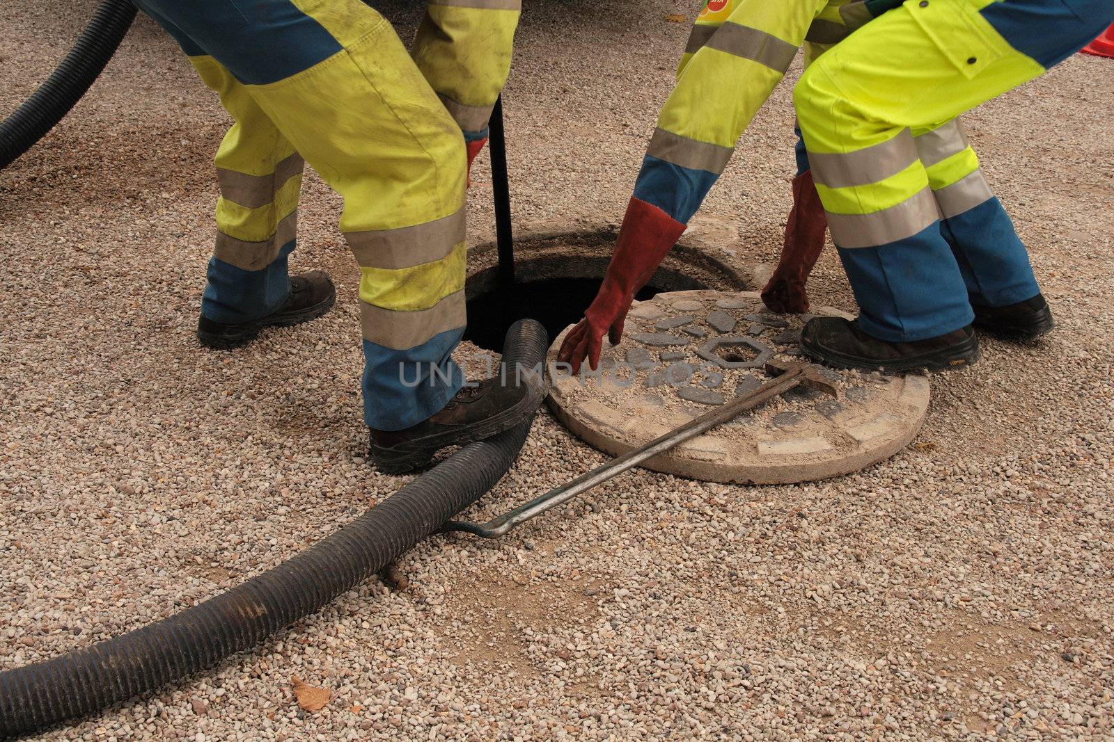 Sewer workers in action, cleaning sewers