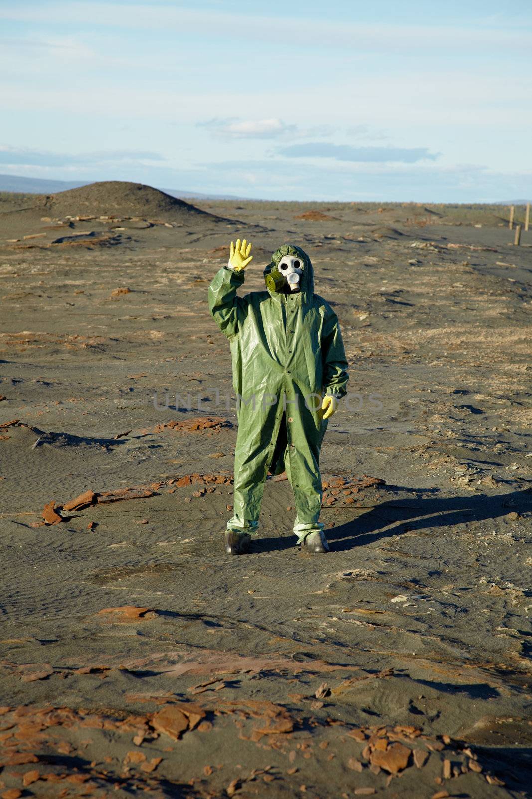 Strange scientist in overalls and gas masks in the desert