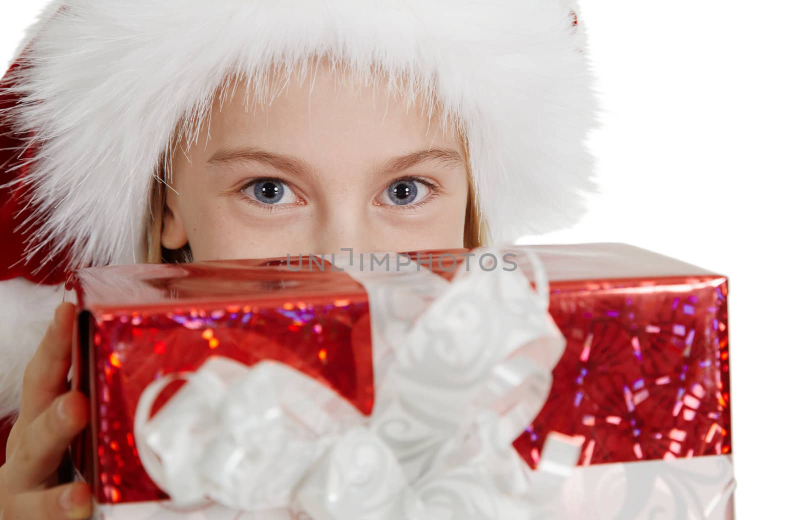 Teen girl in a Christmas hat with a gift of a close-up