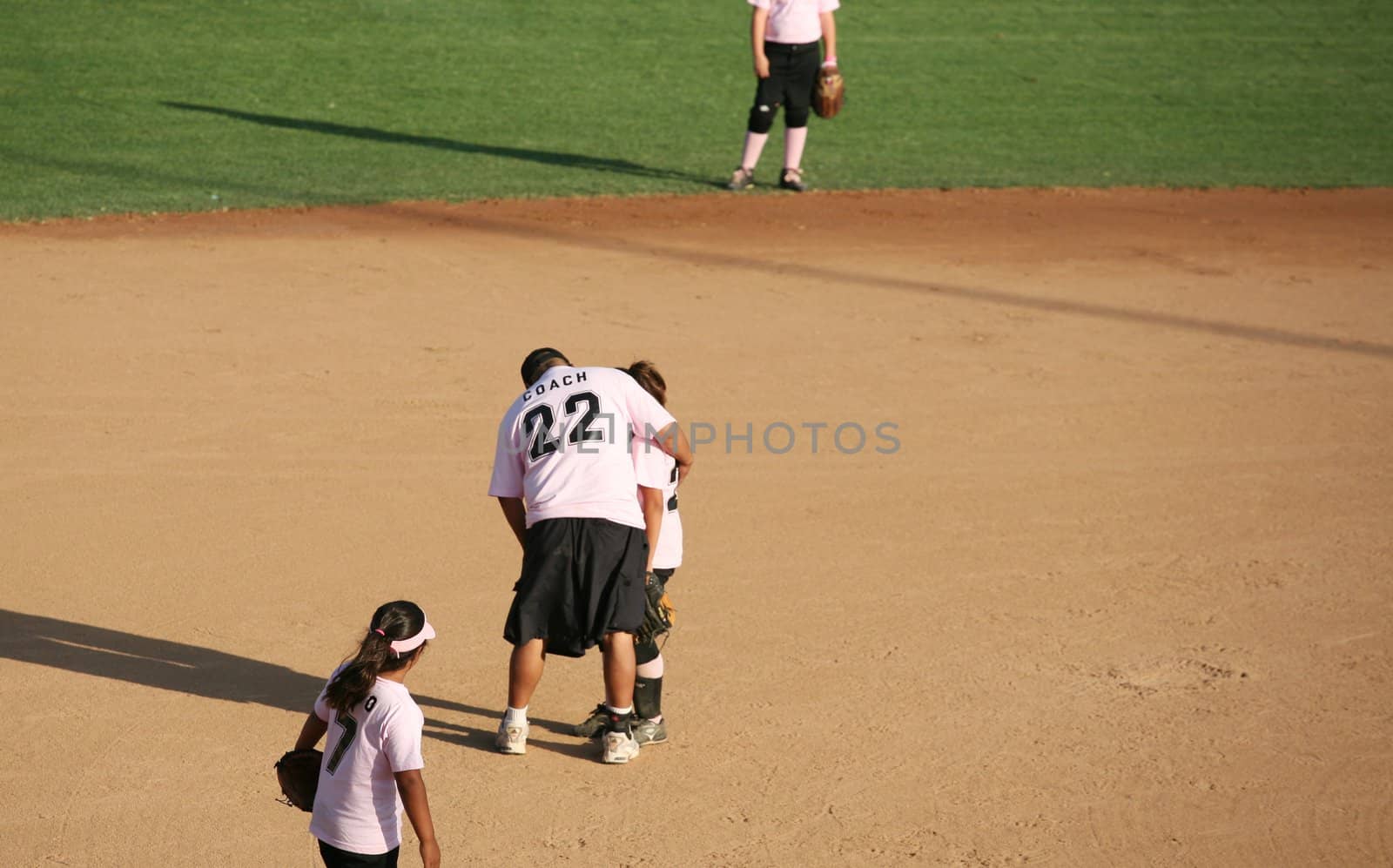 Baseball coach assisting a player
