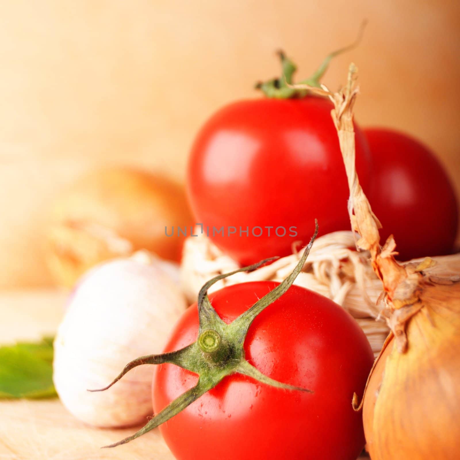 tomatoes and garlic in kitchen on wood with copyspace