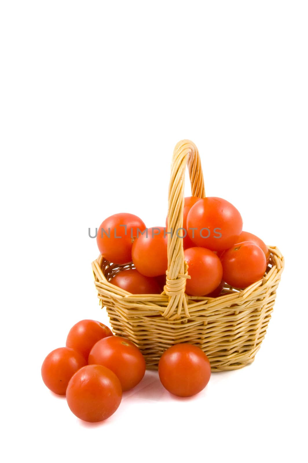 cherry berr ytomatoes in a wicket isolated on white background