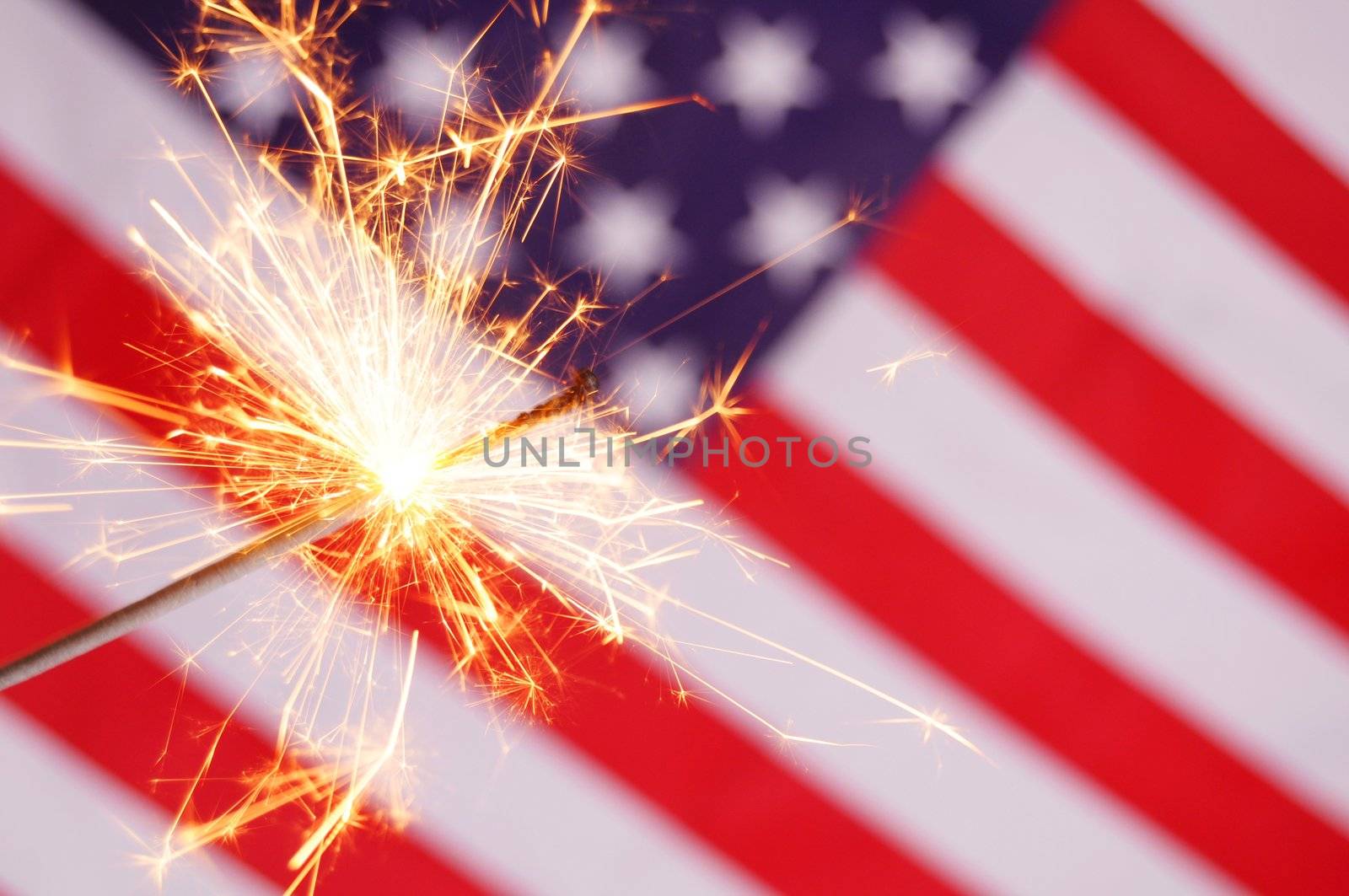 sparkler and usa flag showing 4th of july
