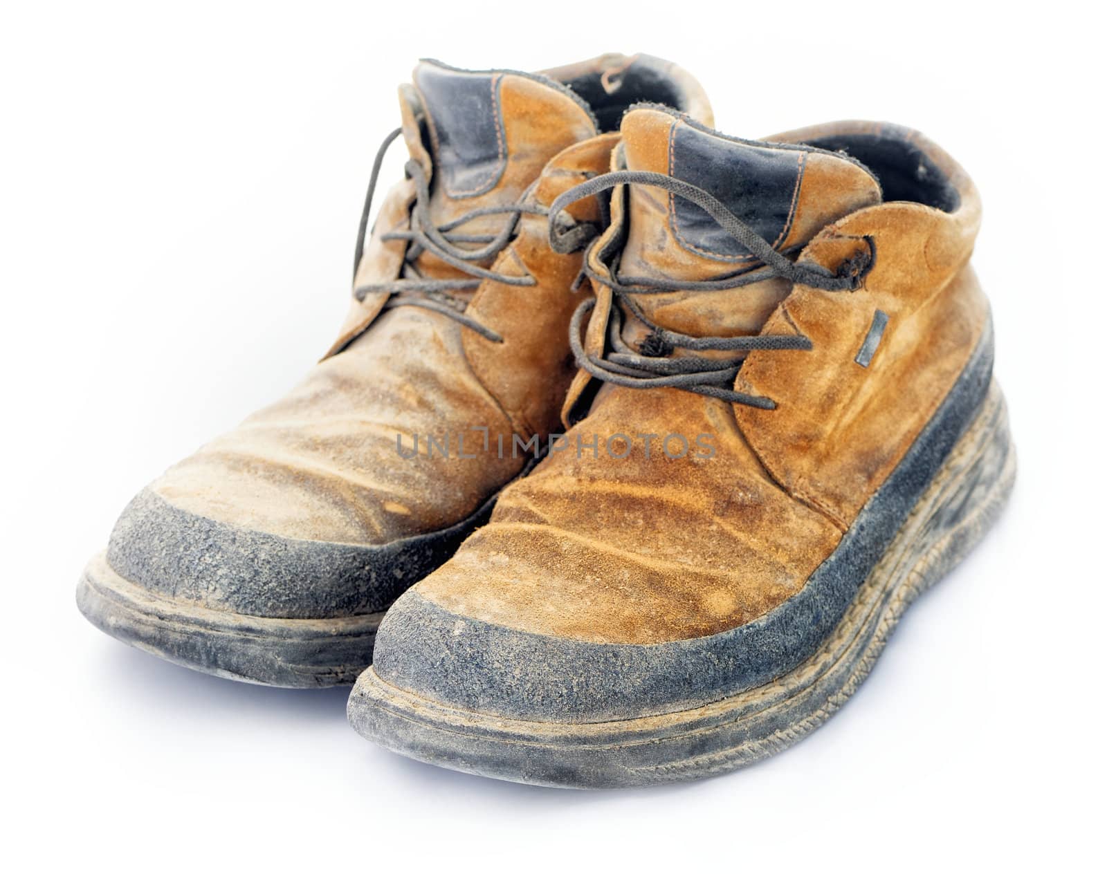 Shabby yellow boots with shoelaces on white background