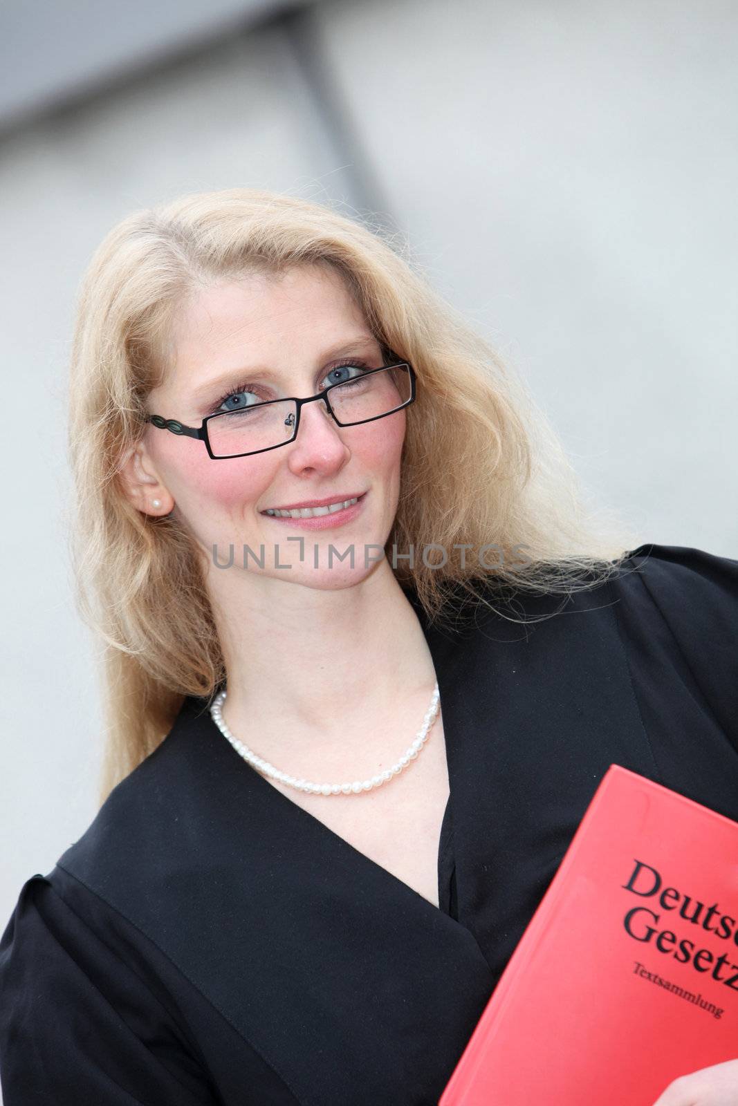 Young lawyer with red Code smiles in the hands
