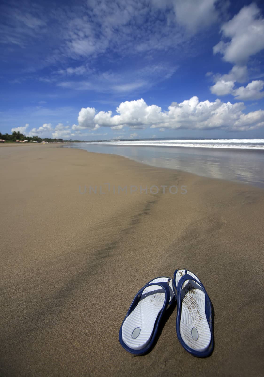 Female slippers on a coast of sea