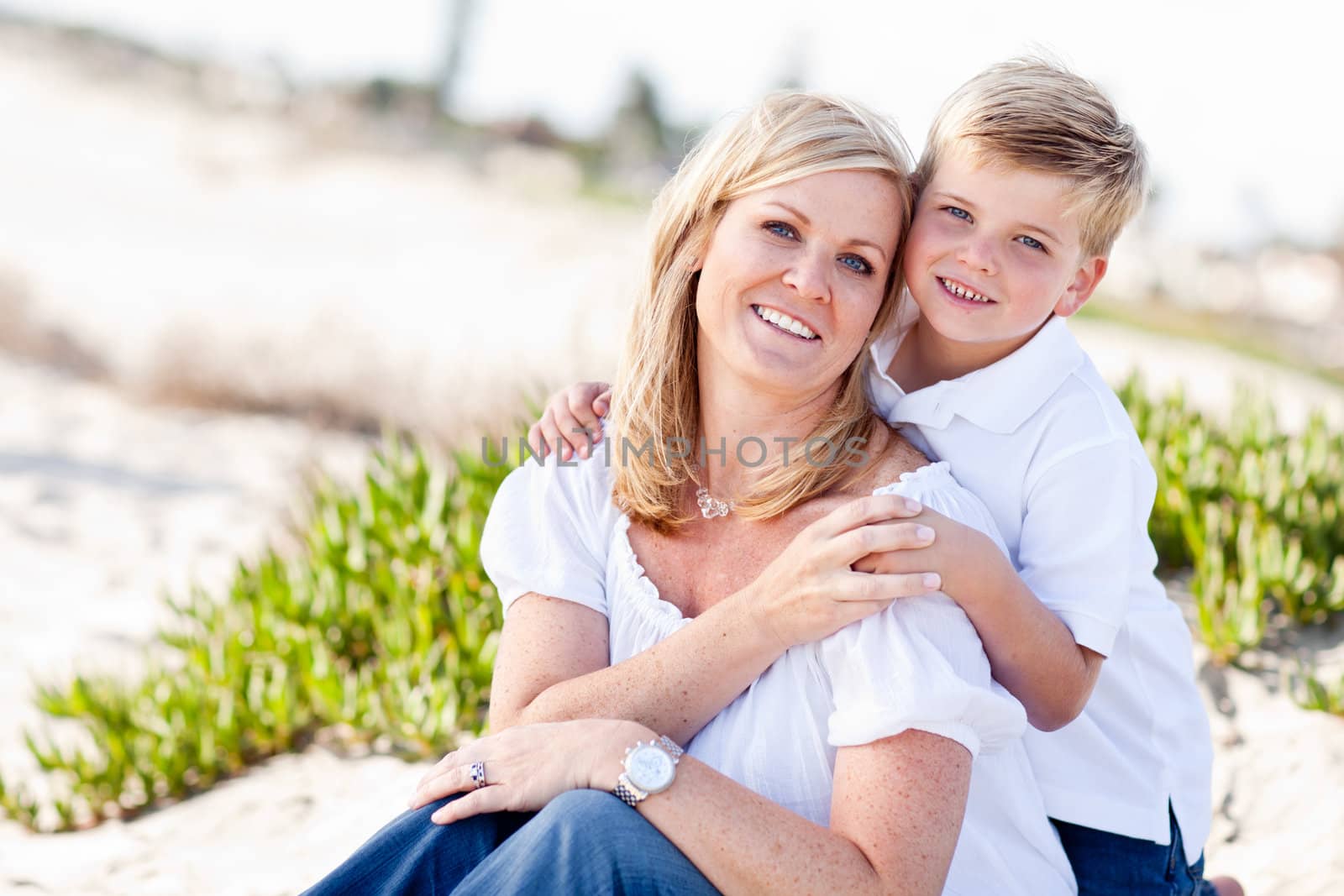 Cute Son Hugs His Attractive Mom Portrait at The Beach.