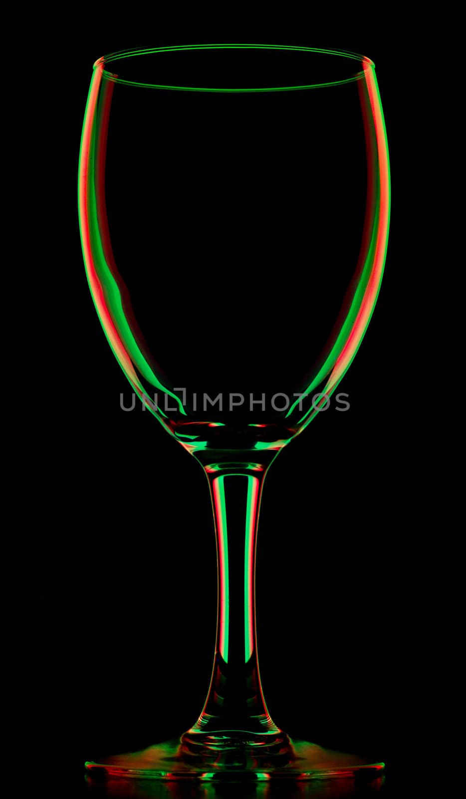 transparent colored empty wine glass, isolated on black