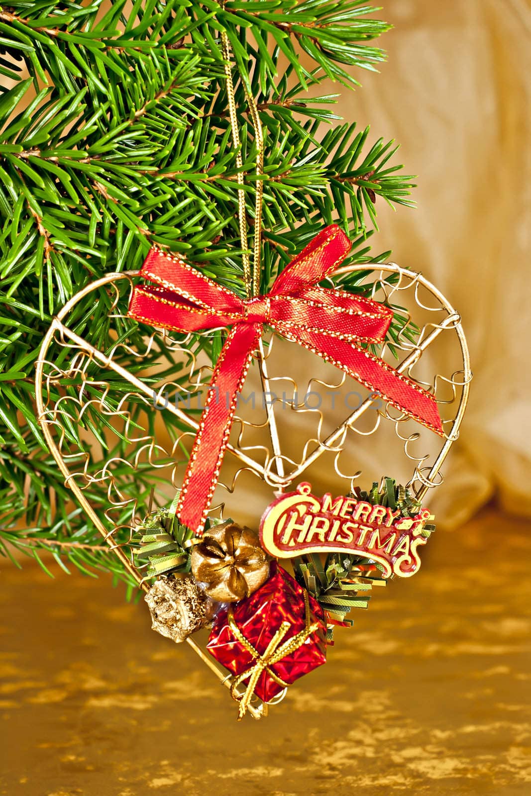 Christmas ornament, fir branch with the decor, and gold background.