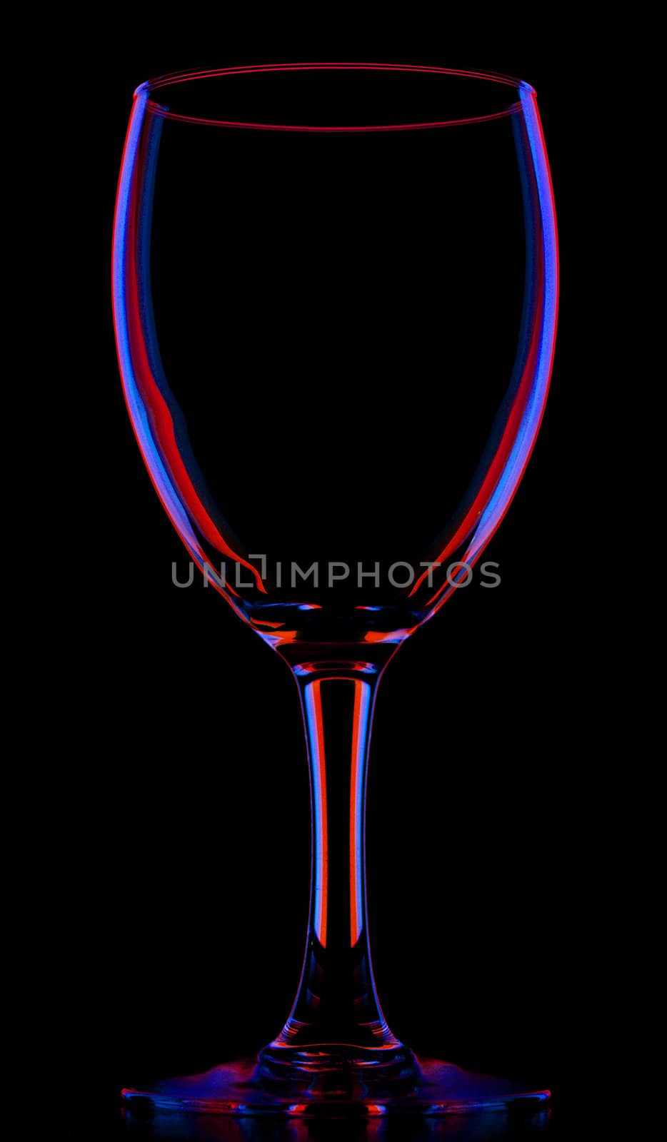 transparent colored empty wine glass, isolated on black