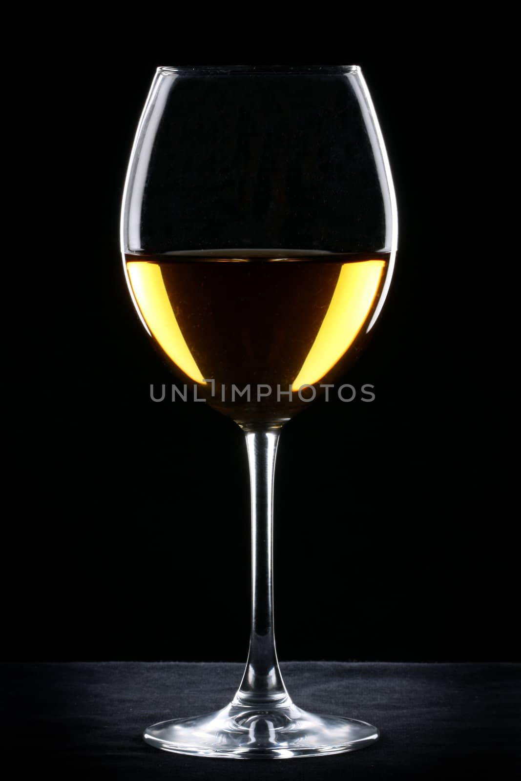 White wine glass silhouette over black background