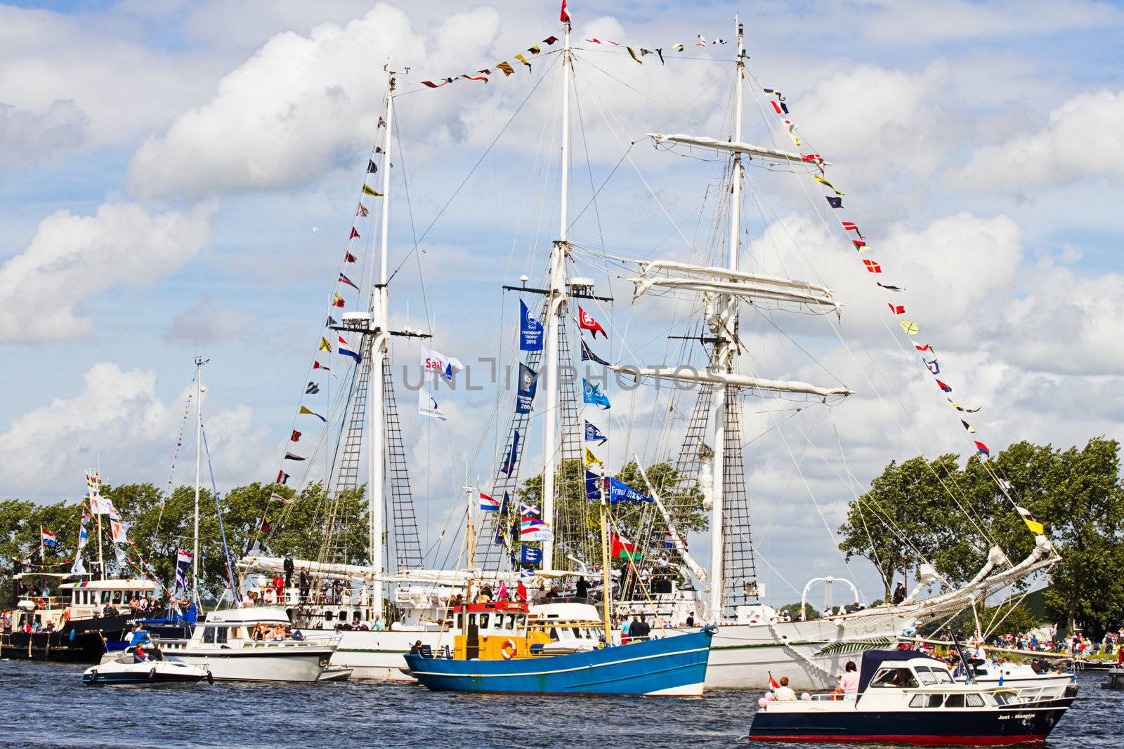 SAIL AMSTERDAM 2010 -IJMUIDEN, THE NETHERLANDS - AUGUST 2010: Sail 2010 starts with the spectaculair Sail-in Parade.  50 Tall ships and more than 500 of  naval ships, replicas and yachts sail in convoy through the North Sea Canal from IJmuiden to Amsterdam. Thousands of private boats accompany the fleet and more than 300.000 visitors watch the parade from the banks. August 19, 2010, IJmuiden, the Netherlands