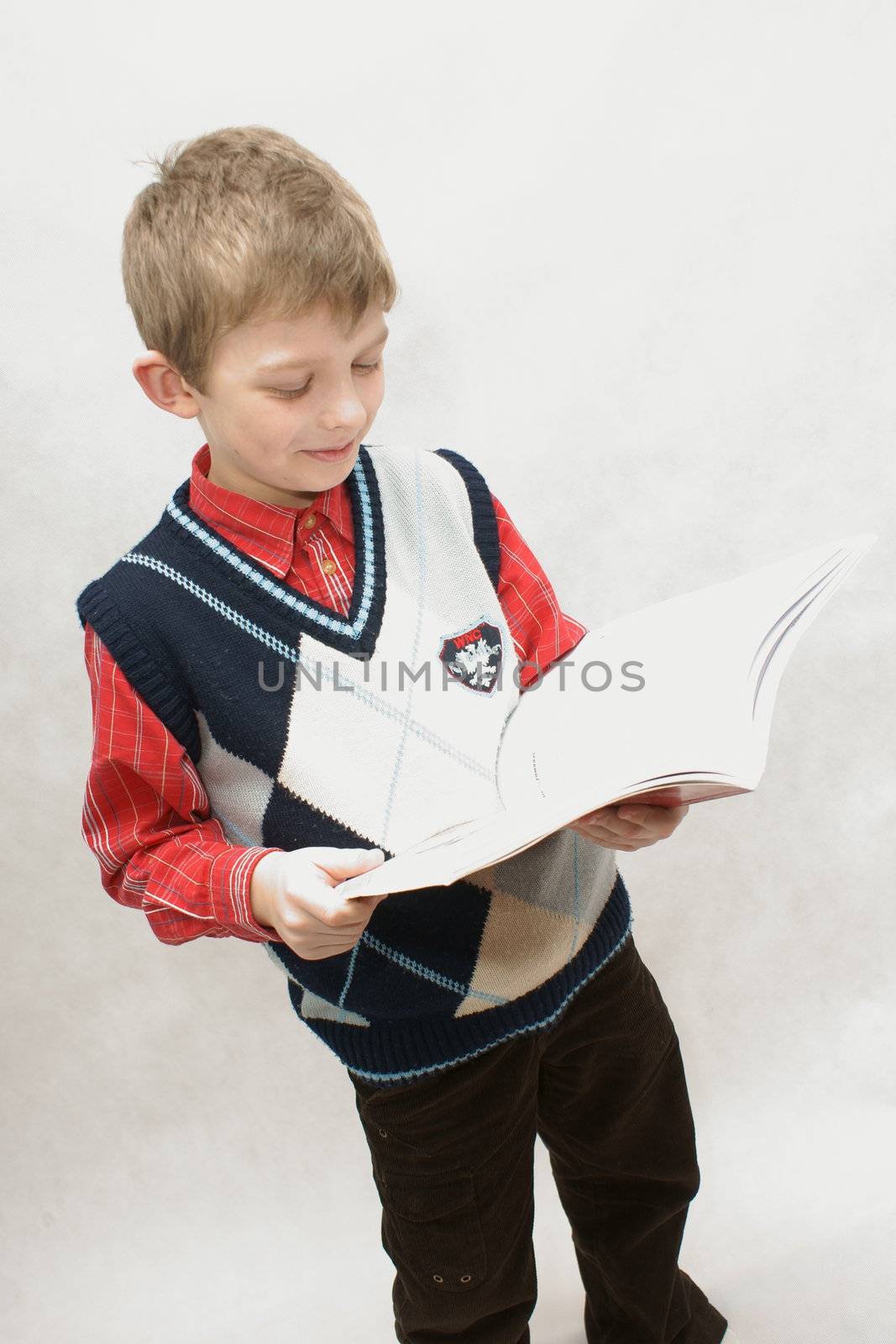 young boy with book in white background