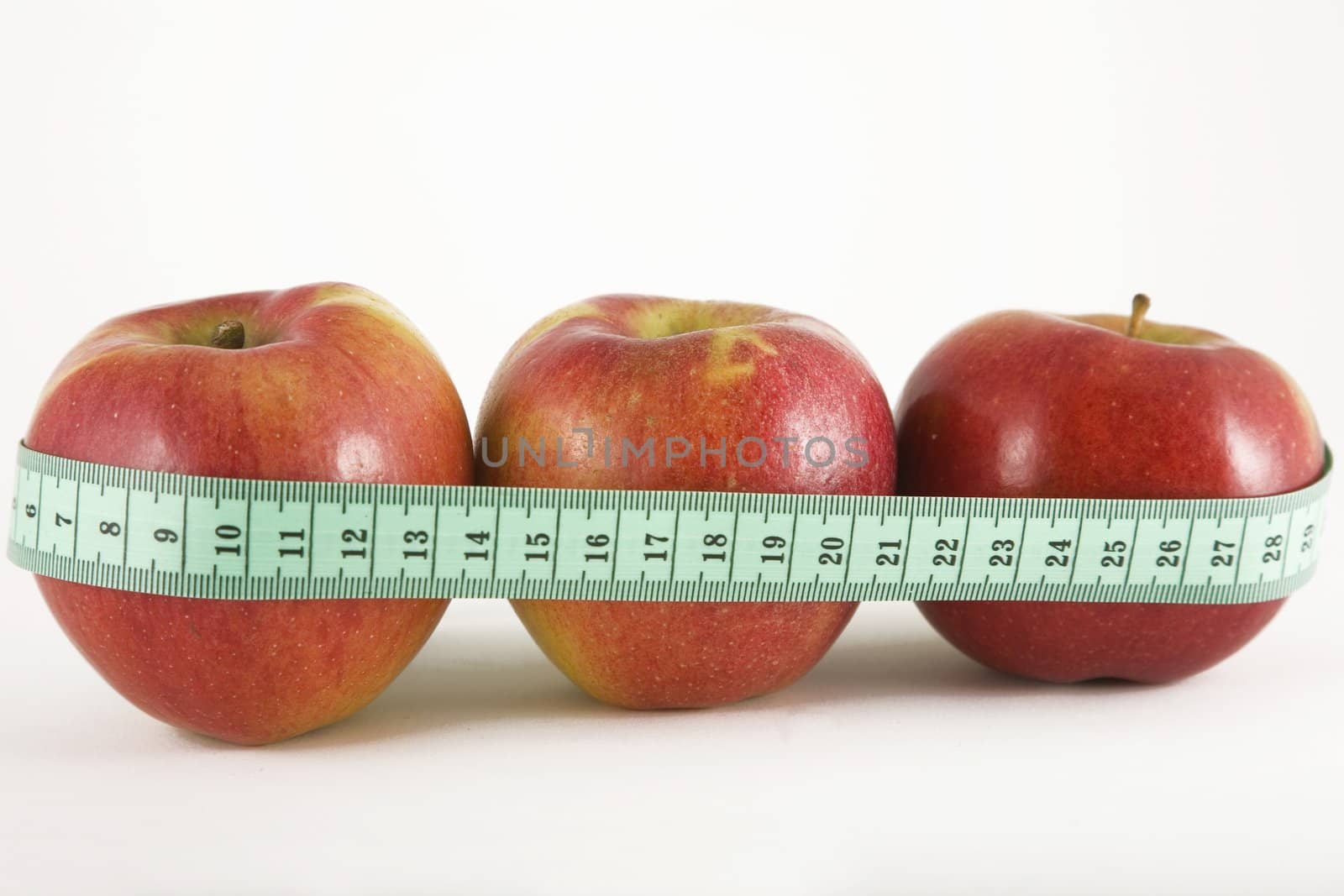 three red apple and green measurement tape, diet and healthy life concept