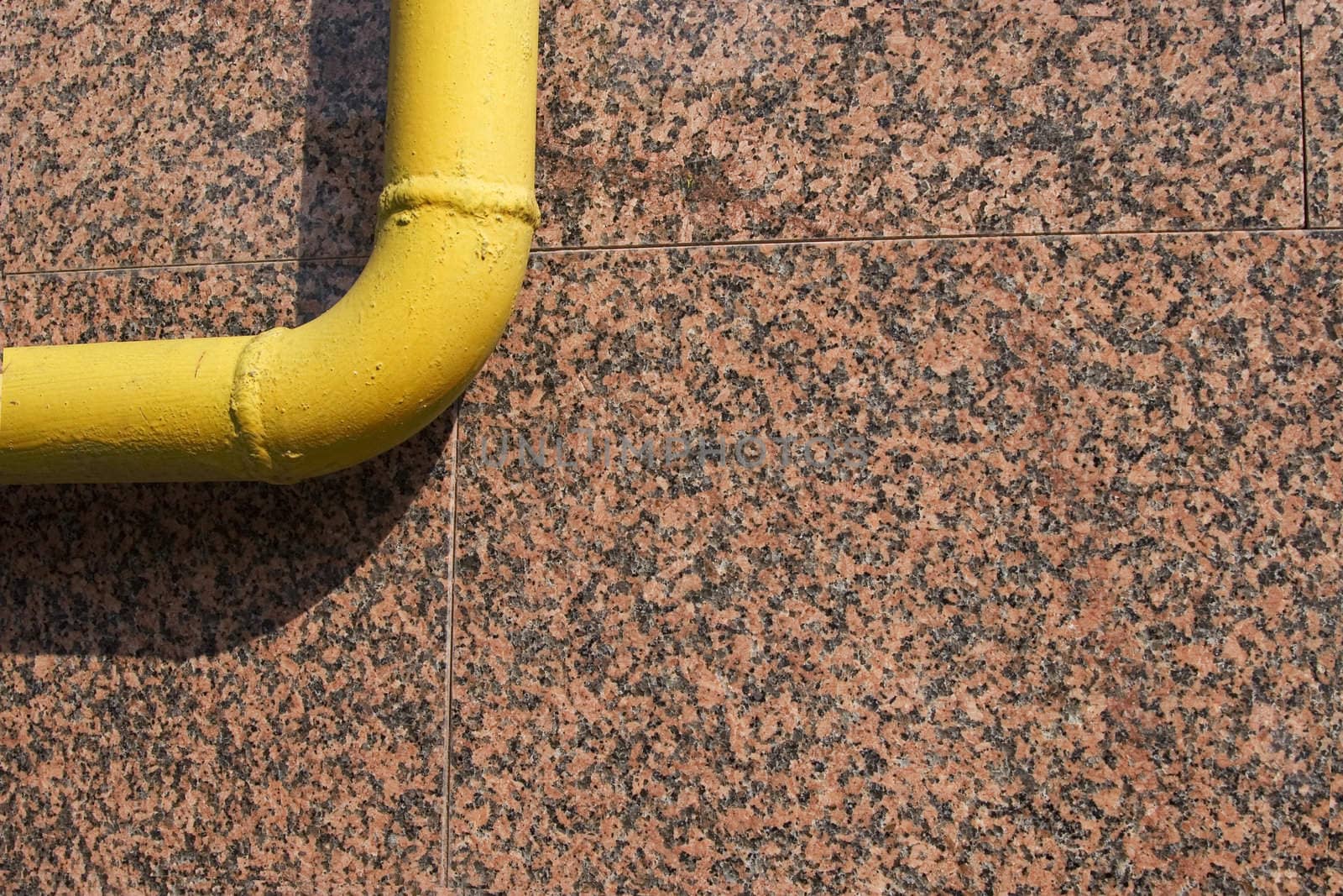 front view of yellow pipe on marble background
