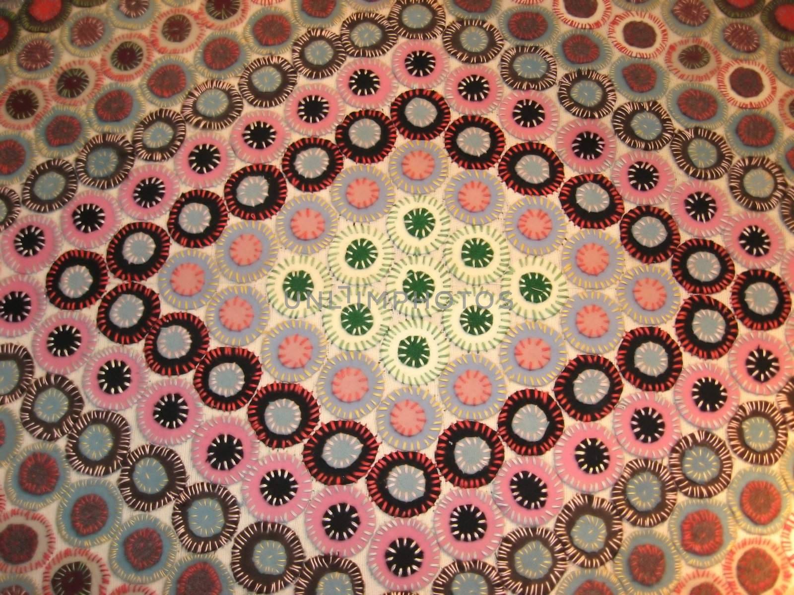 an antique penny rug in a hand made diamond design