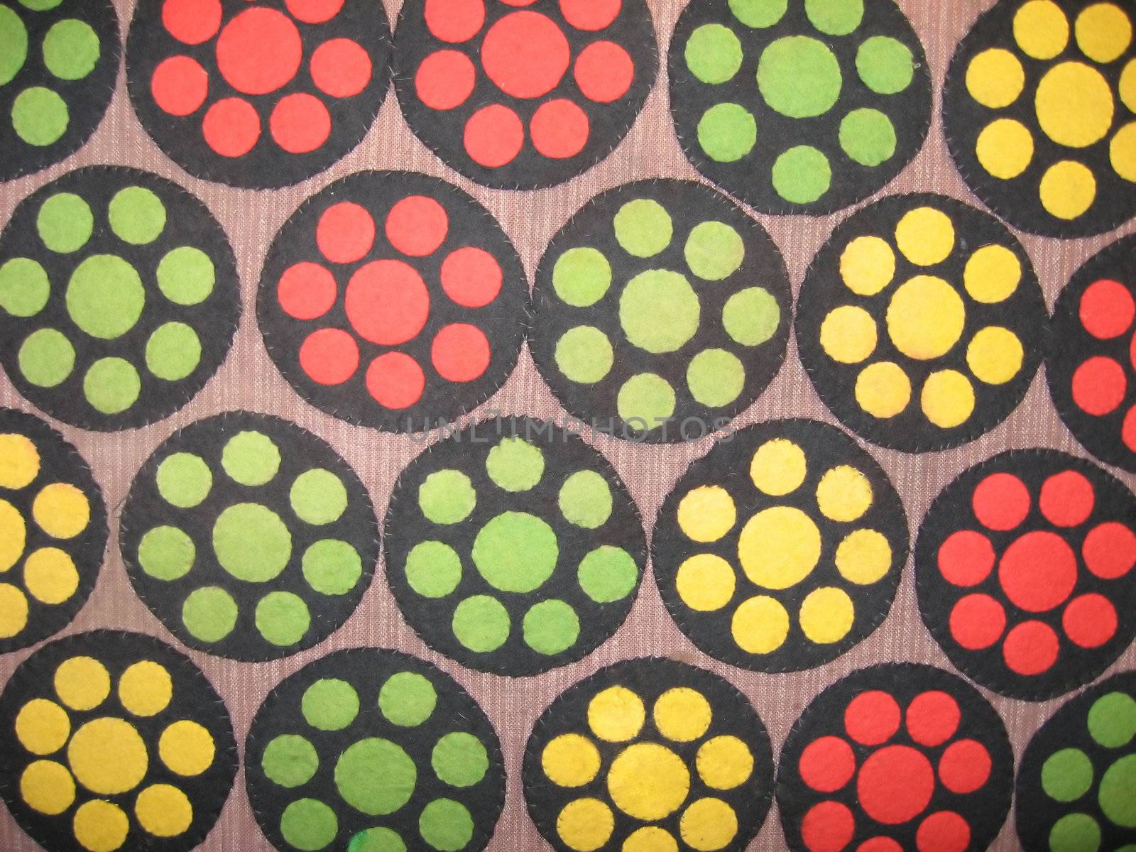 a close-up of a boldly colored antique penny rug showing circles inside circles design