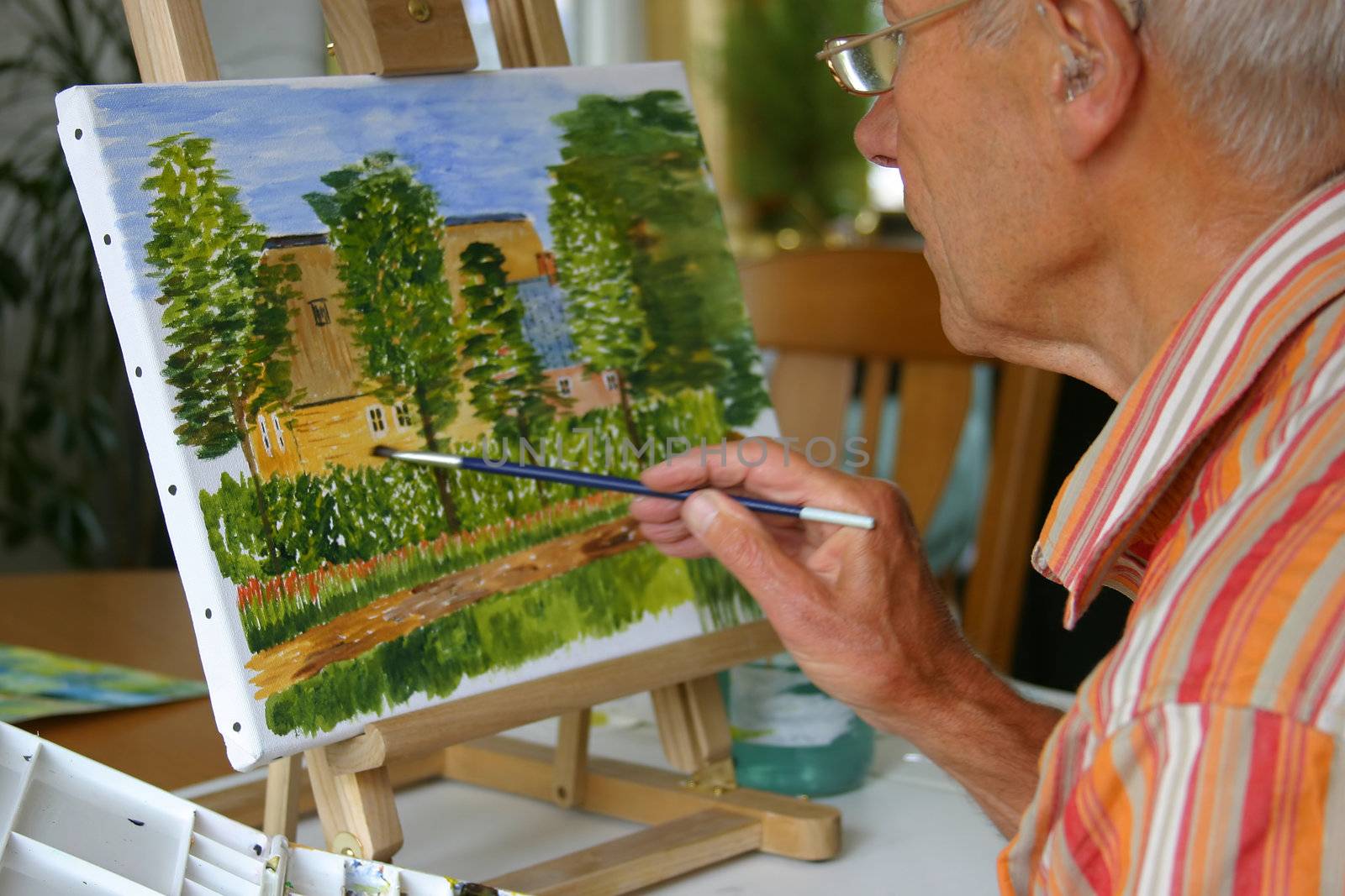 Senior man working on his painting