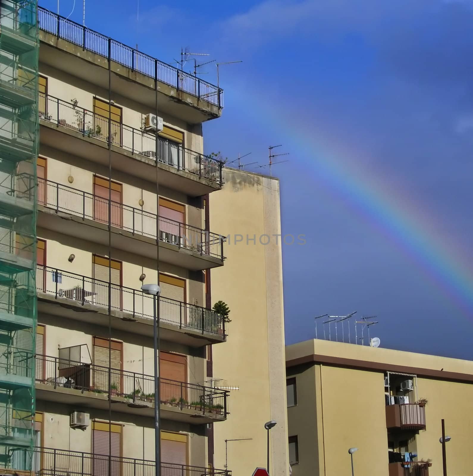 Rainbow over city buildings      