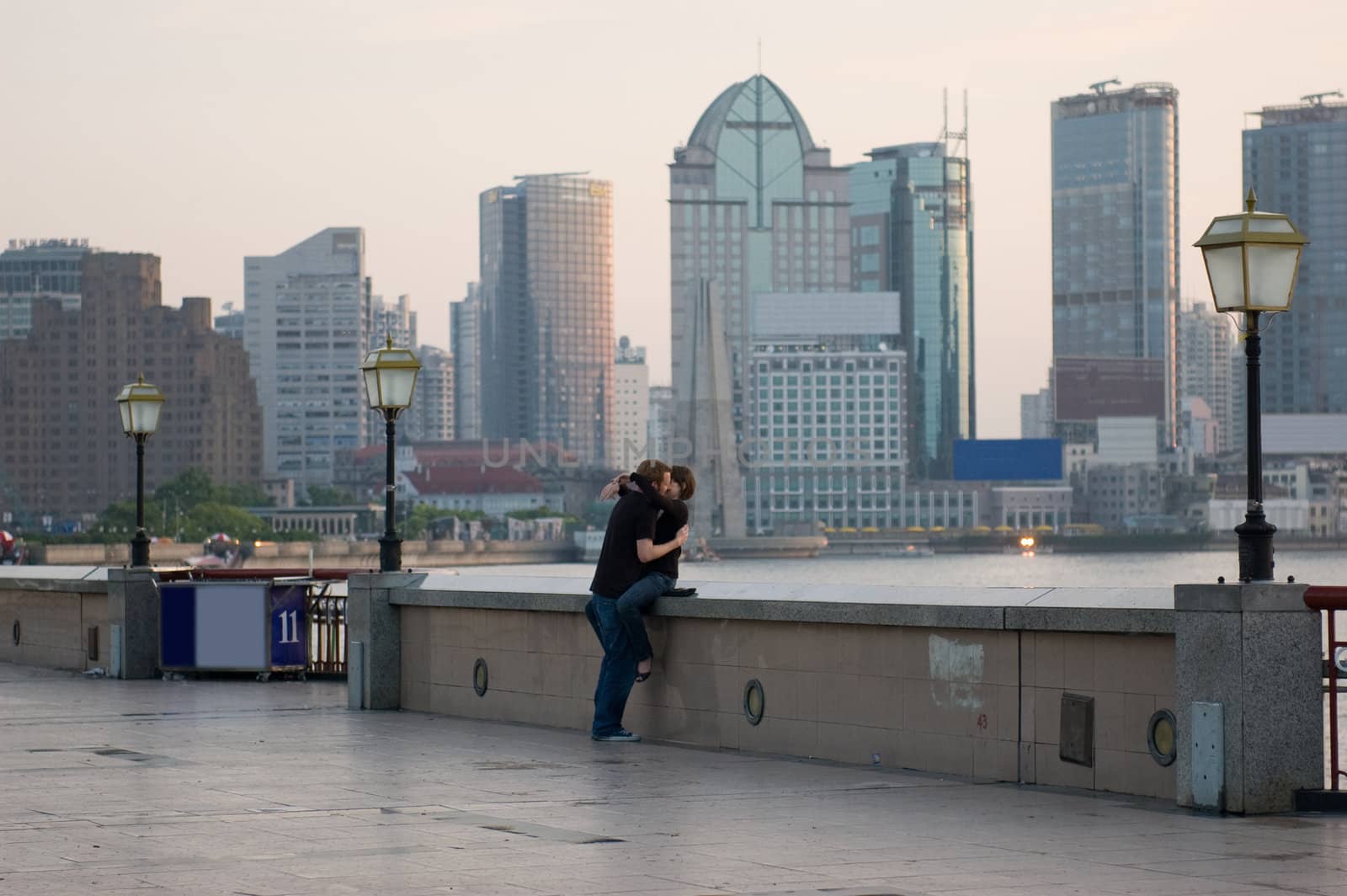 Young couple kissing at sunrise