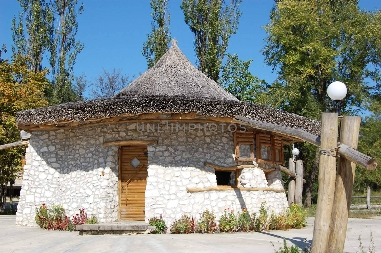 Small stone house with straw roof
