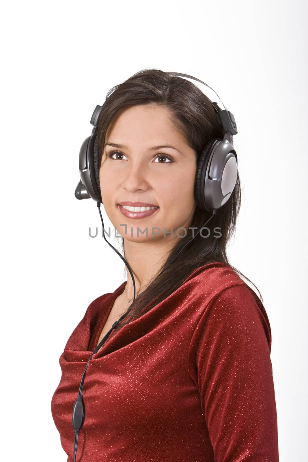 Image of a beautiful brunette with headphones listening to music.Shot with Canon 70-200mm f/2.8L IS USM