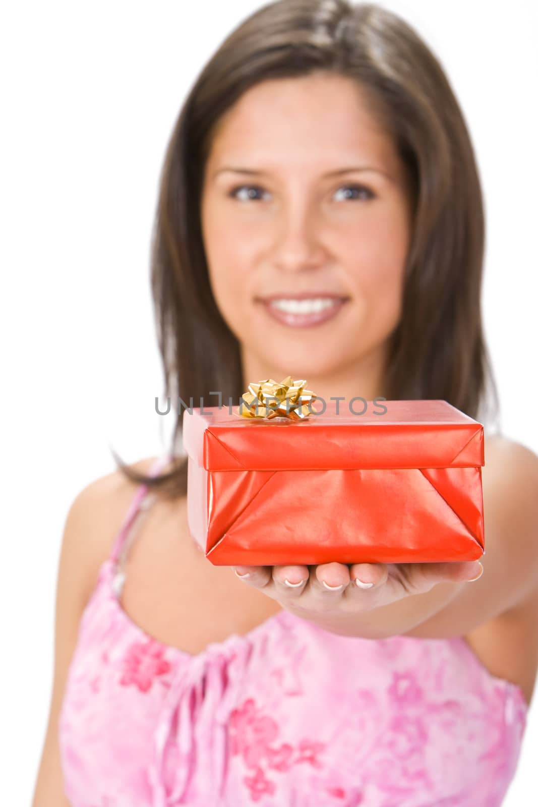 Young brunette offering a red gift box with a bow.Selective focus on the box.Shot with Canon 70-200mm f/2.8L IS USM