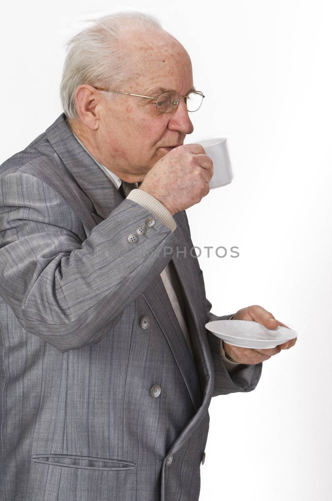 Senior man drinking with pleasure from a coffee cup.Shot with Canon 70-200mm f/2.8L IS USM