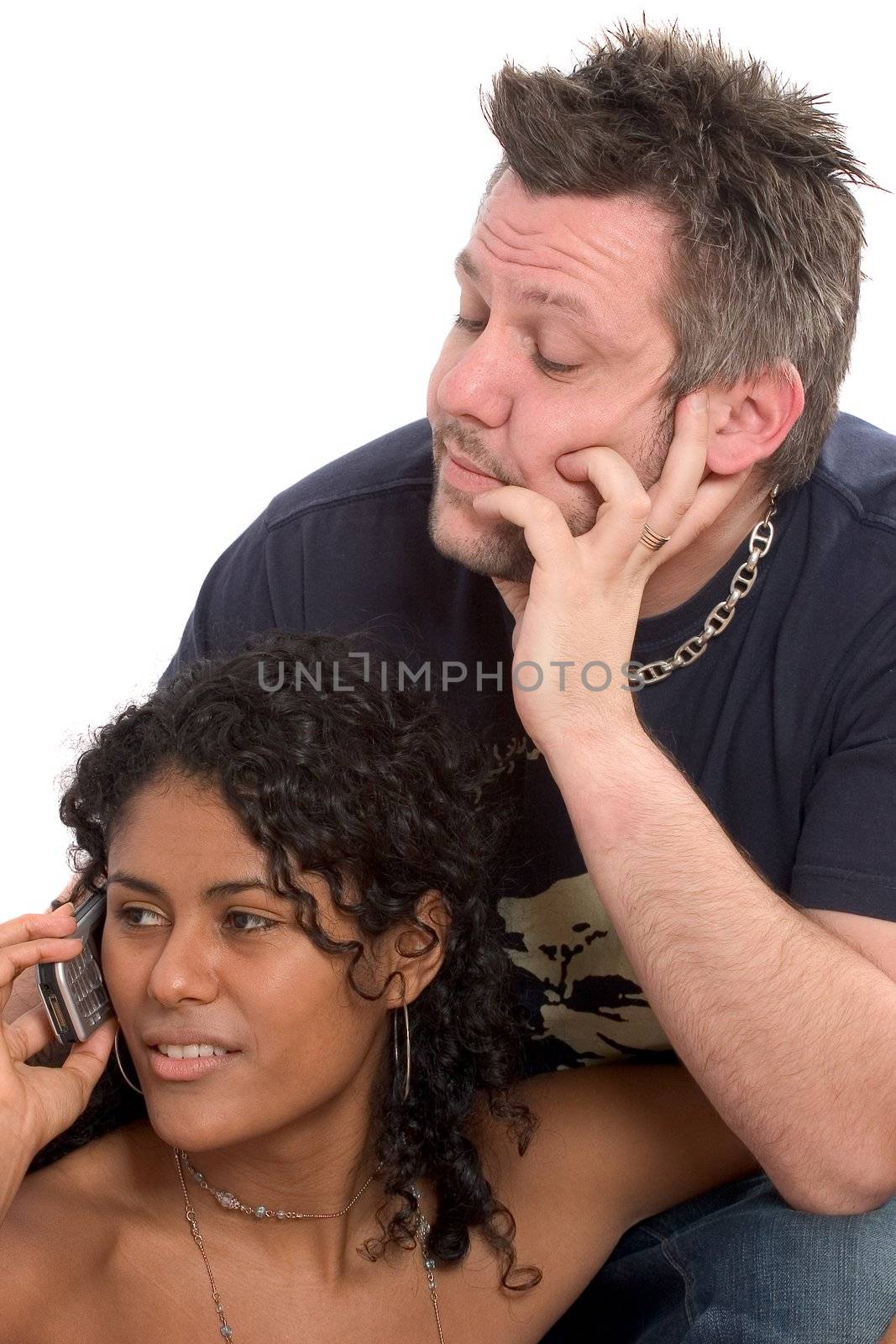 Man looking bored while his girlfriend is talking on the phone by Fotosmurf