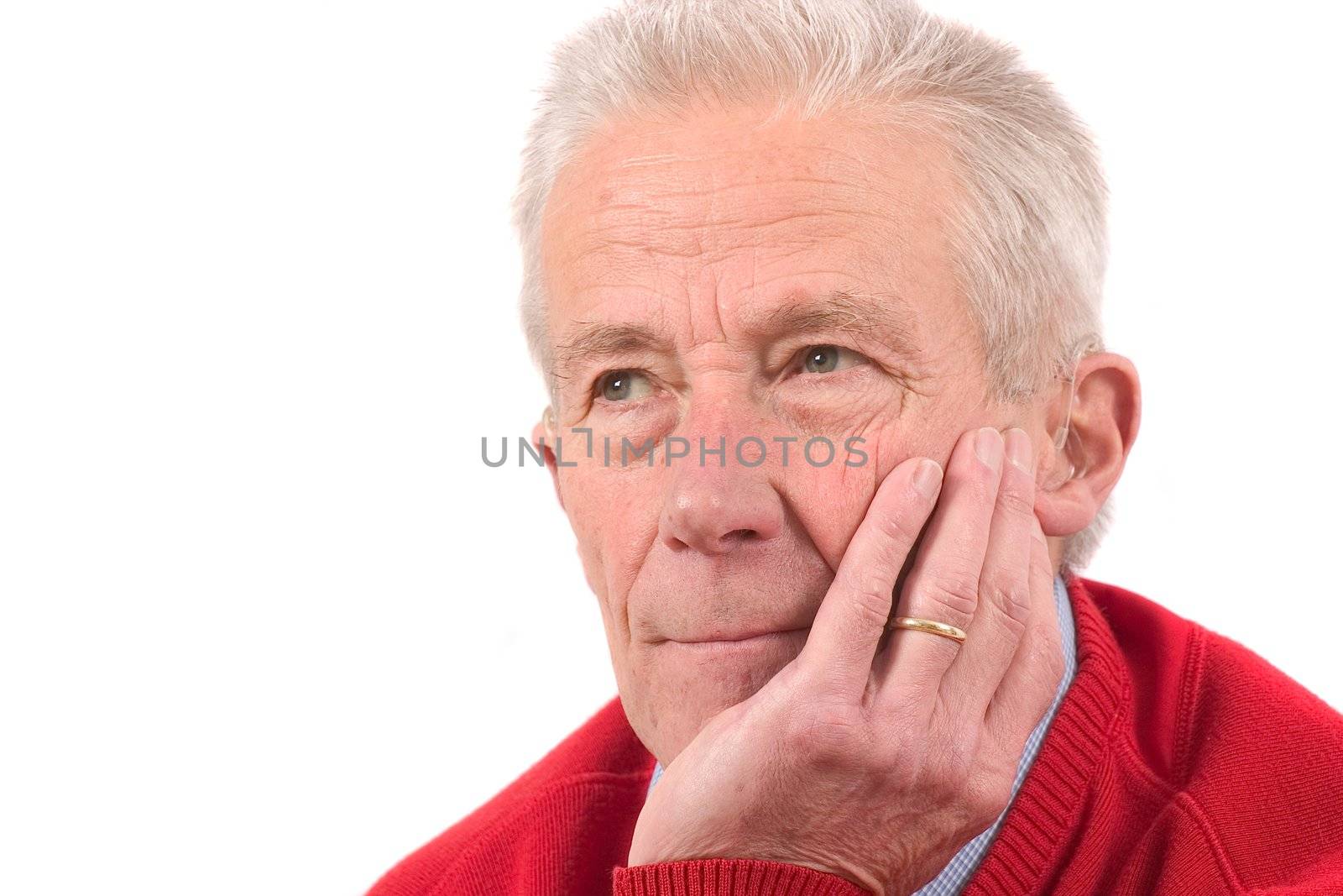Handsome senior man leaning on his hand and looking serious