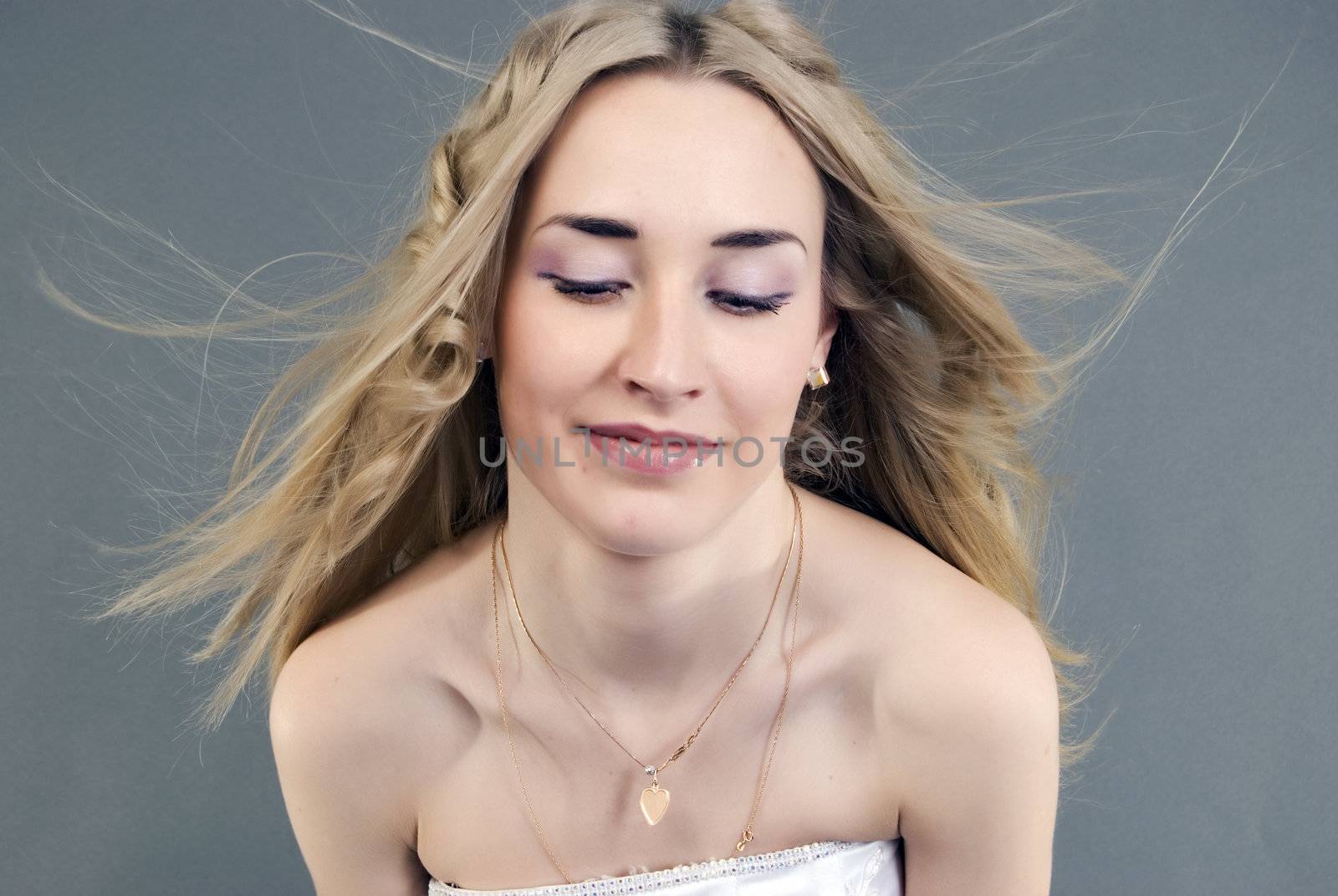 Young beautiful smiling  bride  with closed eyes