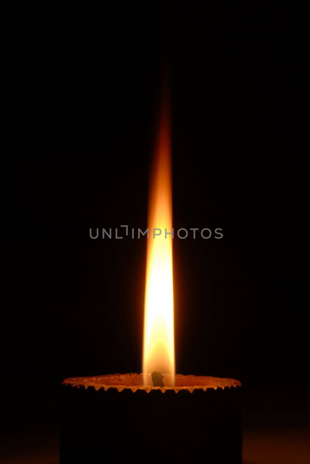 an isolated shot of a Candle Burning at night