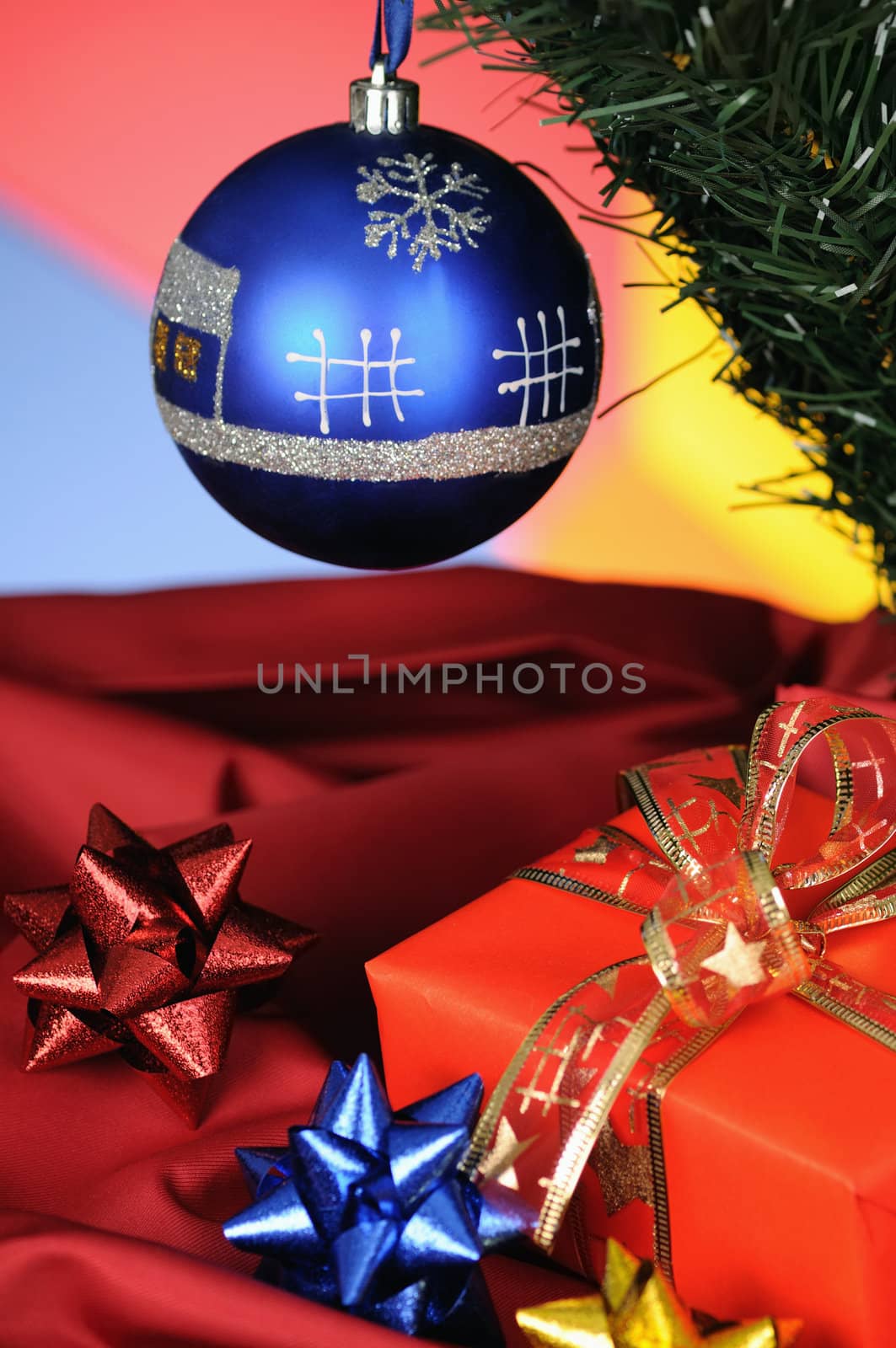 blue christmas decoration and gift on multicoloured background