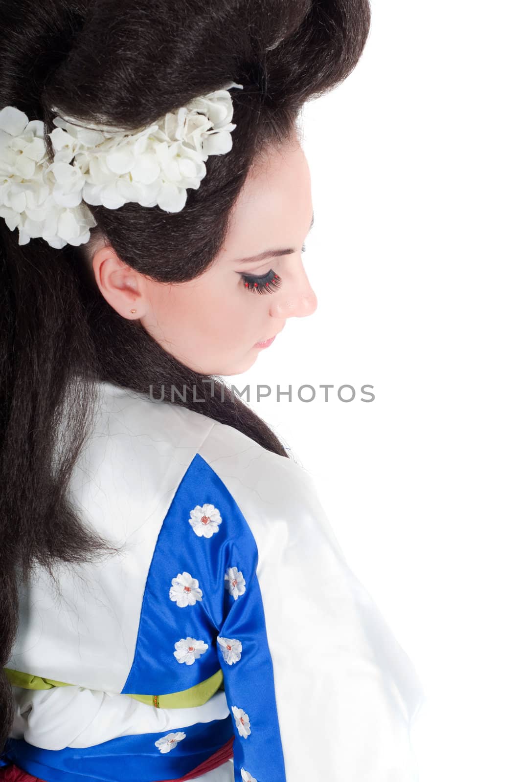 Portrait of the girl of the Asian appearance with a make-up under the geisha on a white background