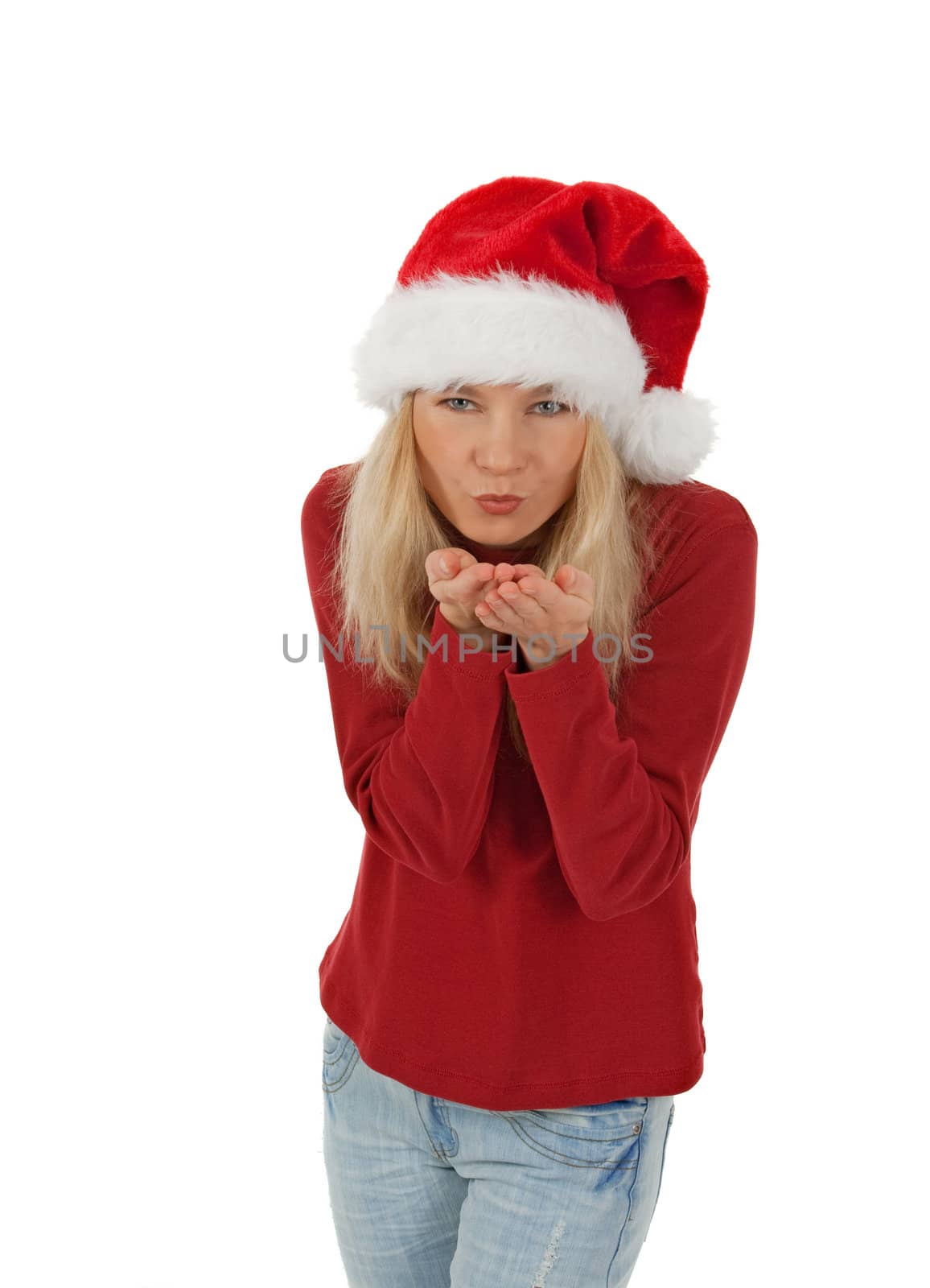 Santa girl wearing Christmas hat sending a kiss. Isolated on white.