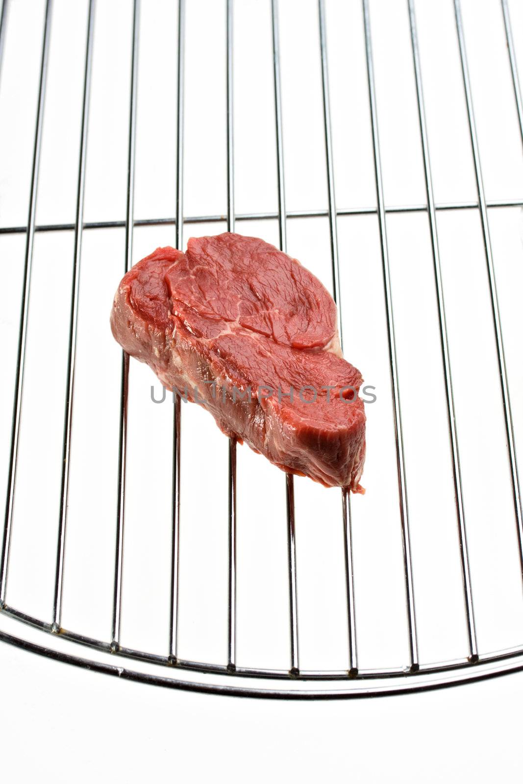 raw steak on a grill isolated on white