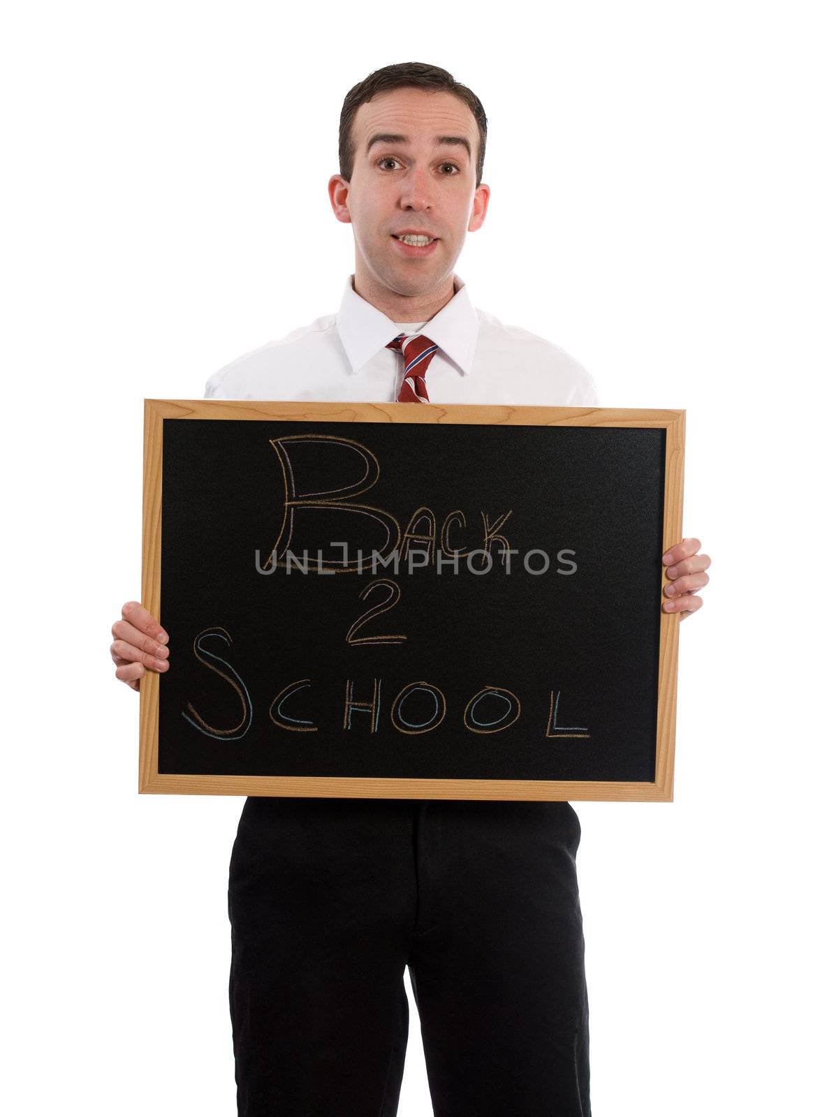 A young teacher is holding up a small black board that read Back to School, isolated against a white background