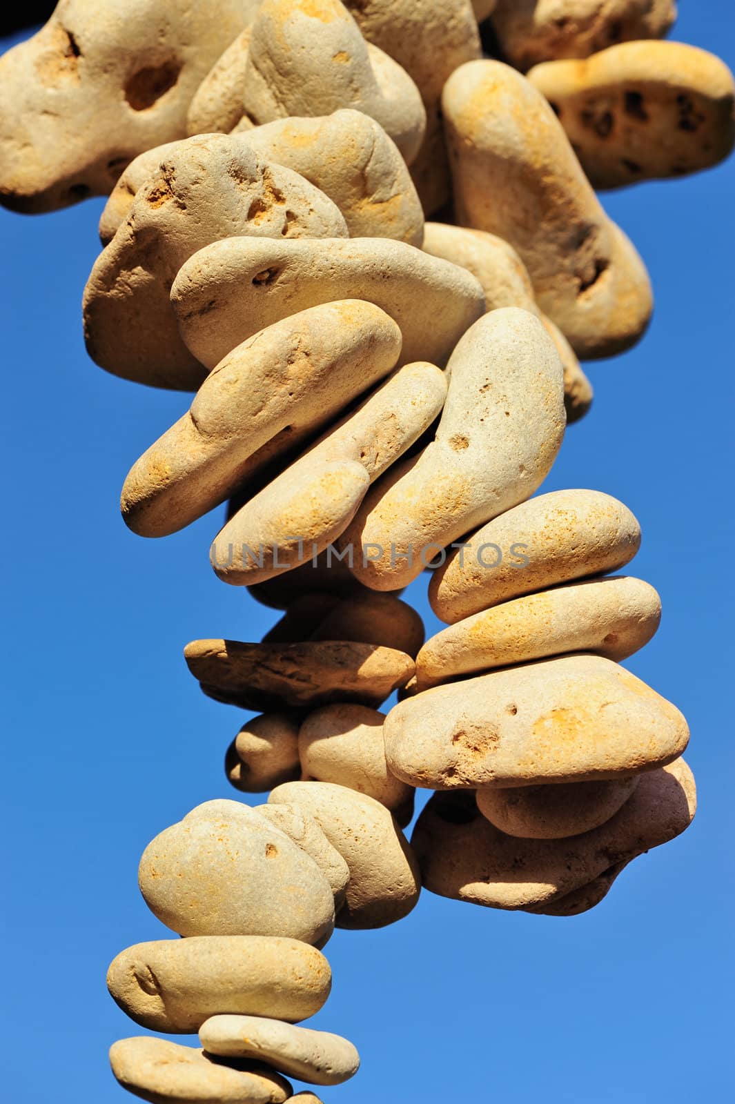 Accumulation of pebbles on the sea-sky background