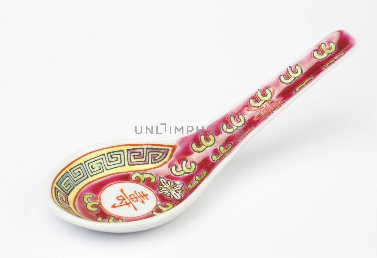 Chinese soup spoon over white background. Studio shot.