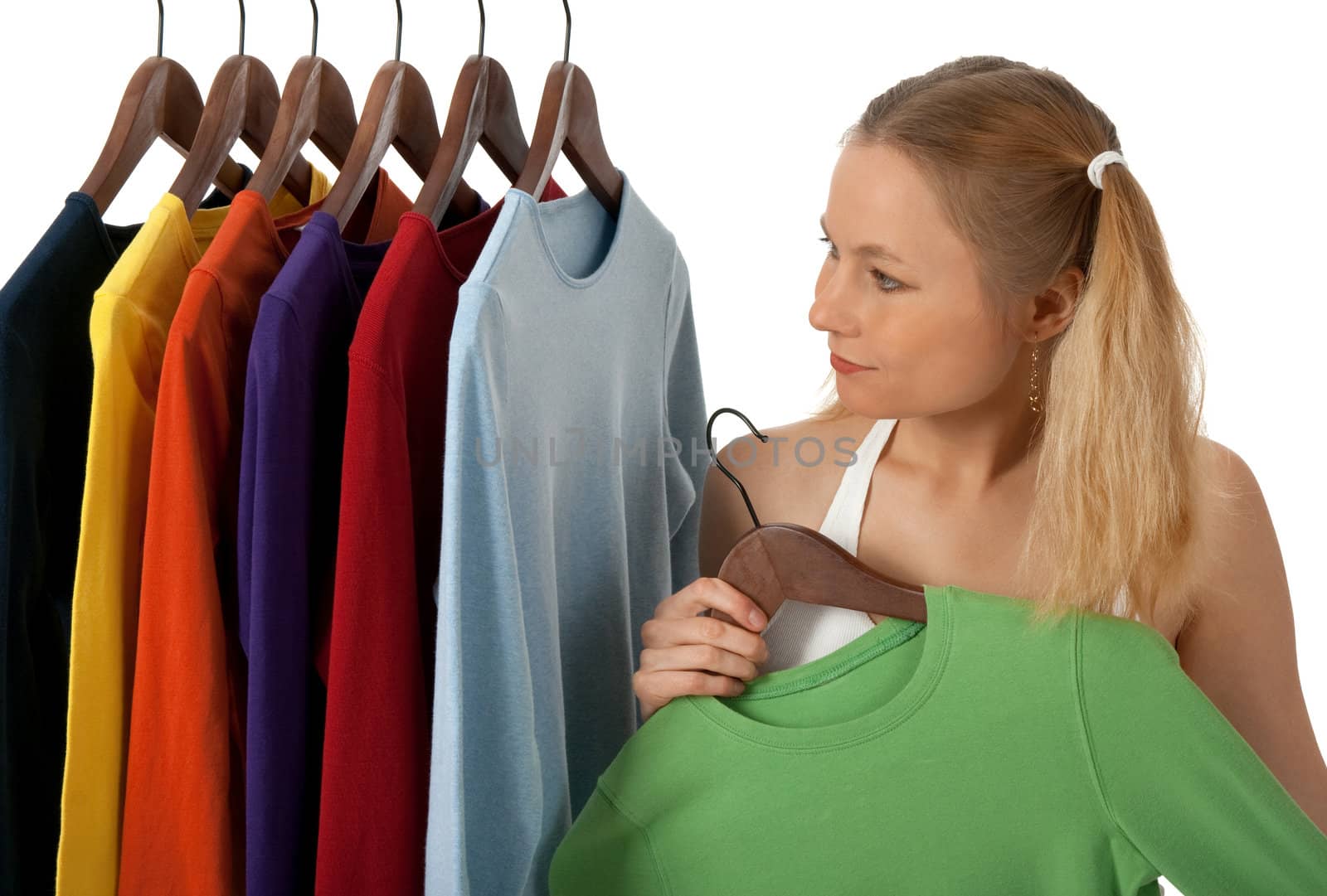 Young woman in a clothing store, choosing clothes to buy.