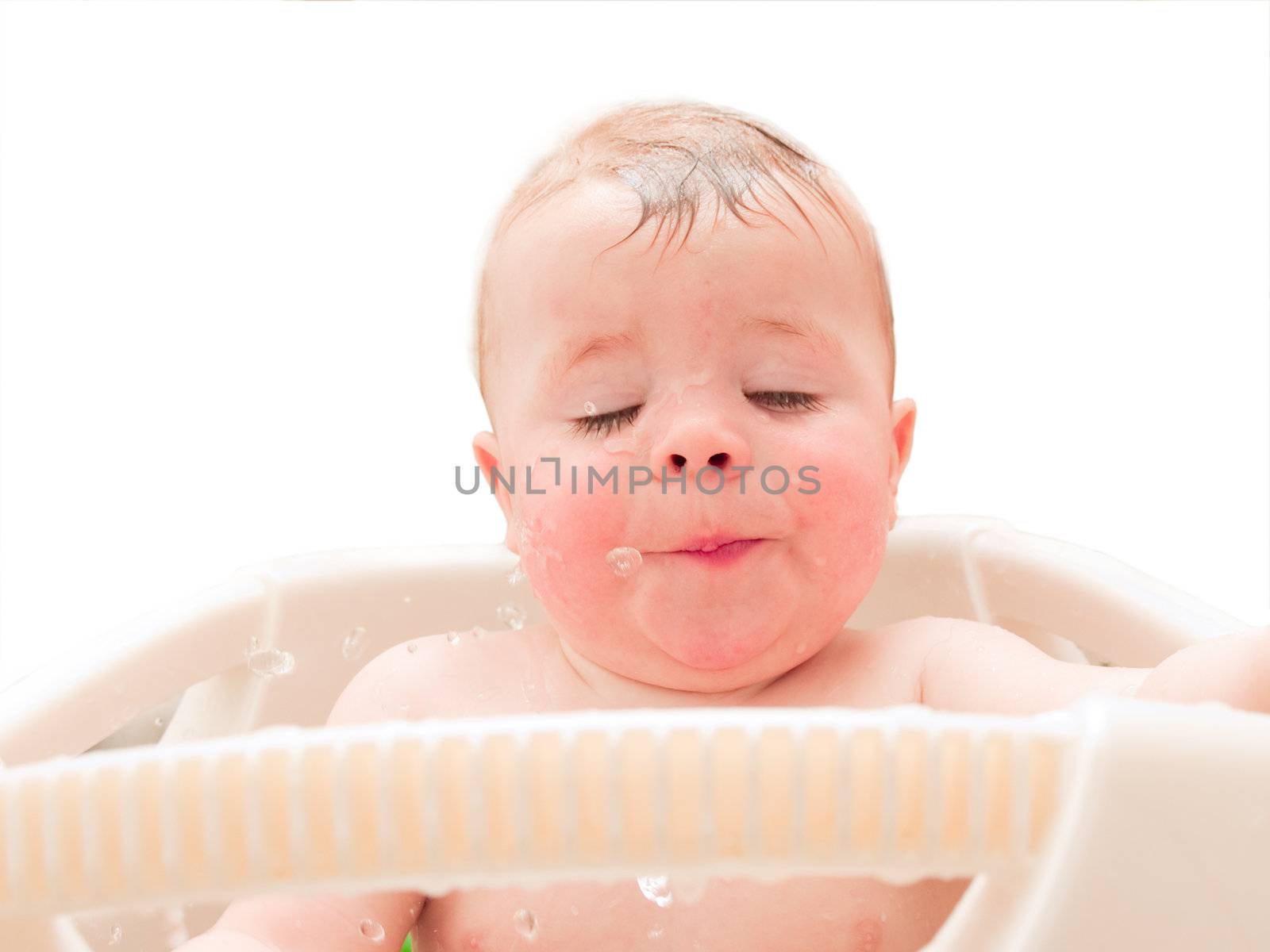 Happy baby boy enjoying water in his bath